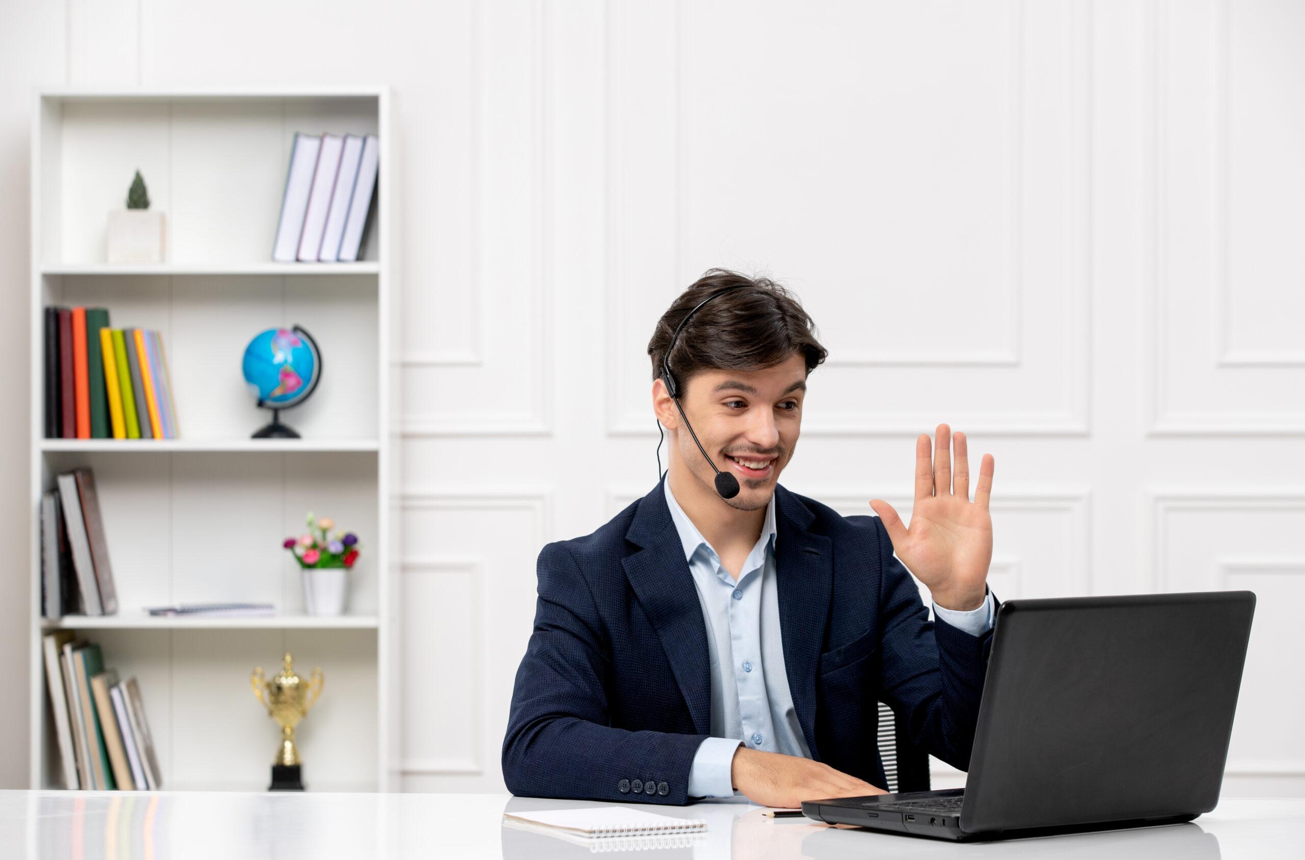 customer service cute brunette guy suit with laptop saying hello headset scaled